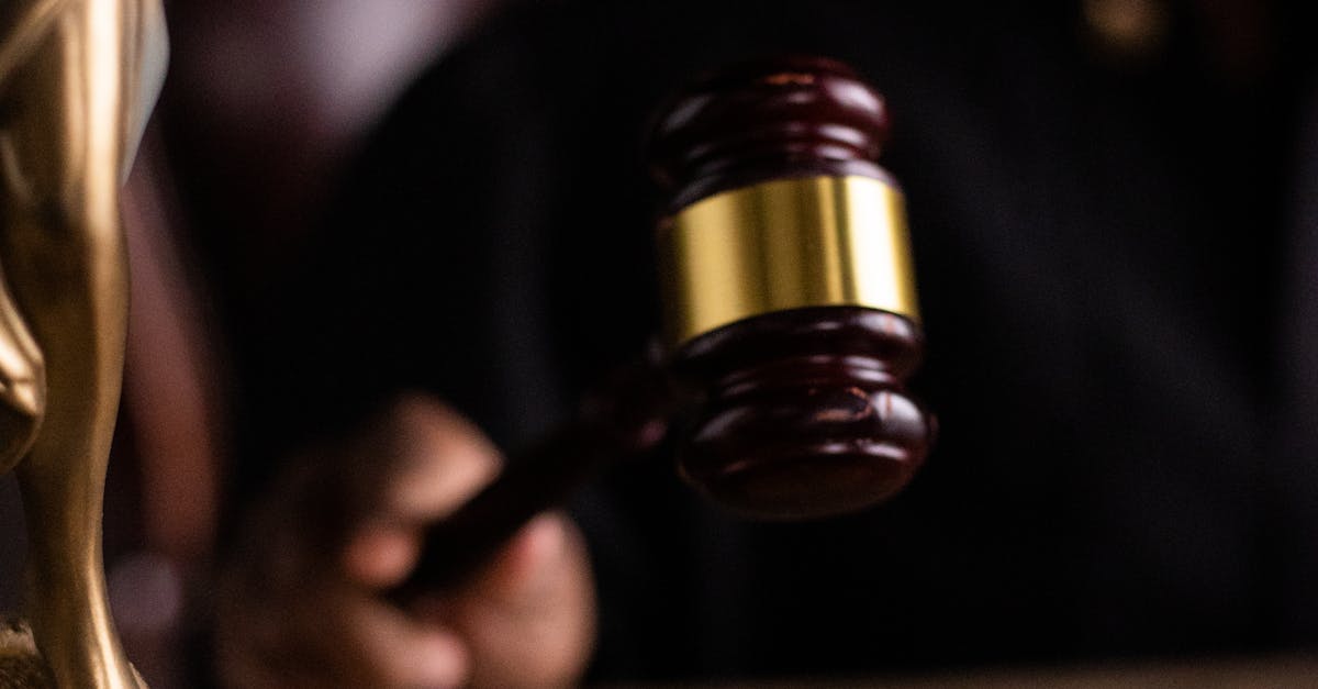 Close-up of a judge holding a gavel, symbolizing justice and law in a courtroom setting.