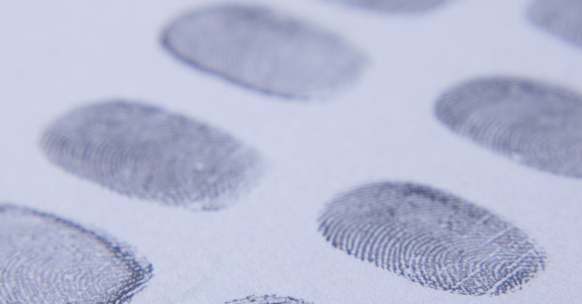 Close-up view of multiple fingerprints stamped on a white piece of paper, showcasing detail and clarity.