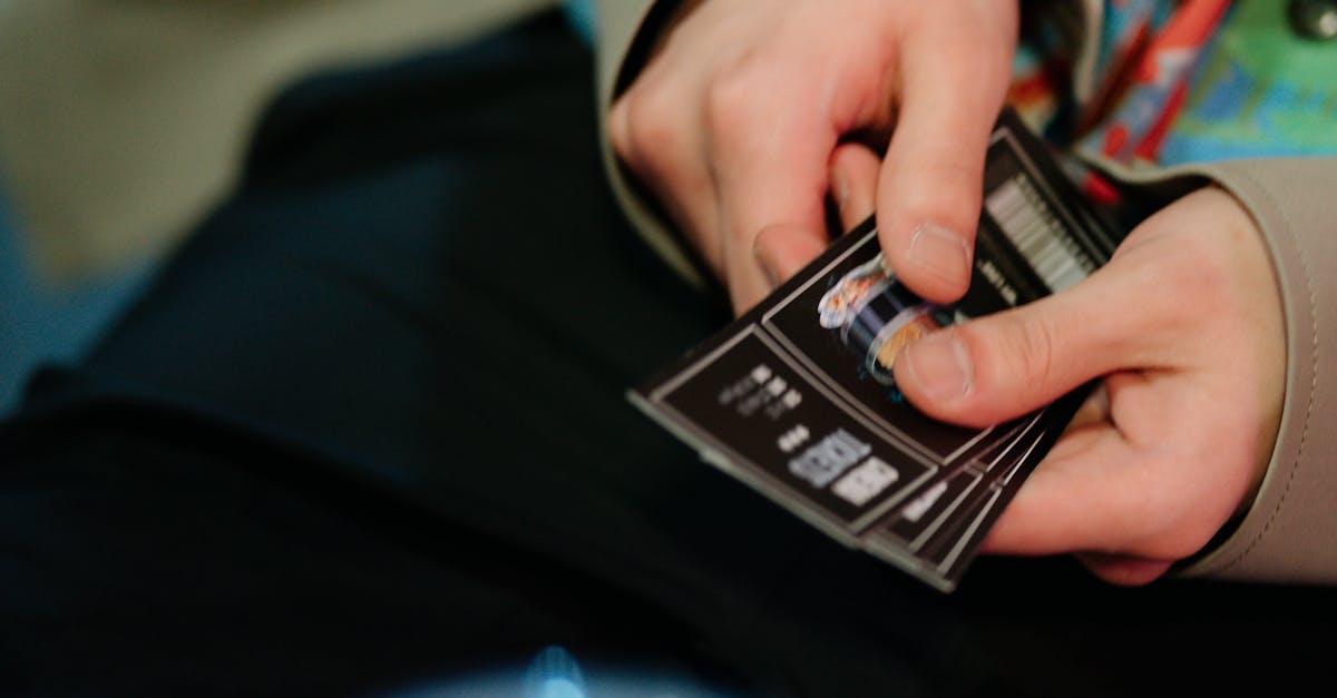 Close-up of hands holding cinema tickets, capturing a moment of anticipation for movie enthusiasts.